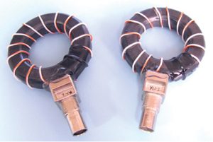 Figure 7. Fig. 7 – Examples of DIY current probes. These photos were taken prior to installing the E-field shield by wrapping a layer of copper tape over the windings, leaving a small gap around the inside of the probe. 14 turns of Teflon-insulted wire wound around a Würth Electronik #74270097 ferrite core (4W620 material) was used, which is useful from 10 to 1000 MHz.