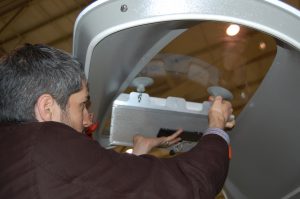An Agile Aperture Antenna is placed in a window of an aircraft for a recent test flight. The software-defined, electronically-reconfigurable antenna can change beam directions in a thousandth of a second. Its light weight and low power requirements make it ideal for use in UAVs. (Photo: GTRI)