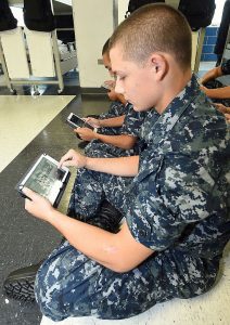 150813-N-IK959-875  GREAT LAKES, Ill., (Aug. 13, 2015) Seaman Recruit Donald Shrupp uses an electronic tablet during a study period in his barracks, USS Hopper, at Recruit Training Command (RTC). Part of the Master Chief Petty Officer of the Navy's eSailor initiative, Naval Service Training Command launched the second cycle of the pre-pilot  with recruit Division 947. The second cycle of testing will help determine how well the device integrates into the training environment at RTC. The e-tablets contain RTC curriculum, including training videos, texts and access to professional development websites. (U.S. Navy photo by Scott A. Thornbloom/Released)