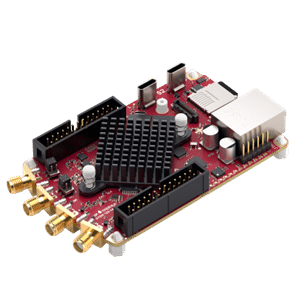 Angled view of an FPGA-based multifunction measurement board, similar to a RedPitaya, with multiple coaxial RF connectors, pin headers, a central heat sink, and surface-mounted components.